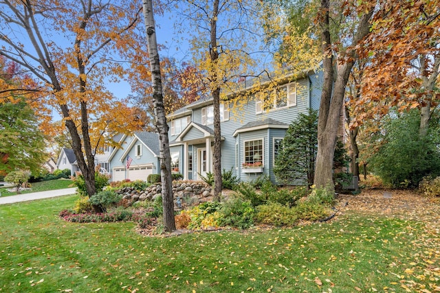 view of front of property with a garage and a front yard