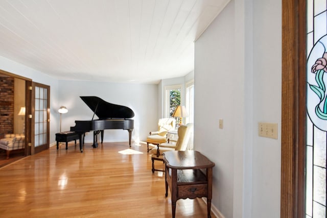 living area with light wood finished floors and baseboards