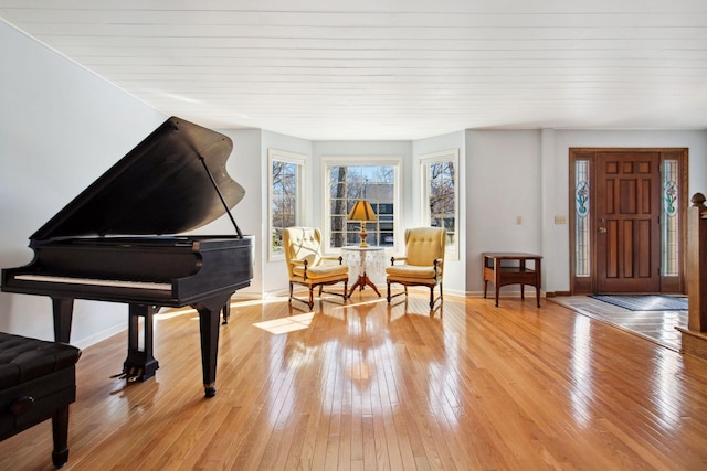 living area featuring baseboards and light wood-type flooring