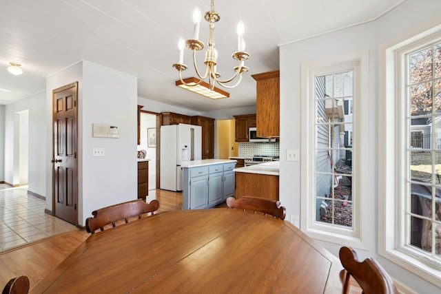 dining room with an inviting chandelier and light tile patterned flooring