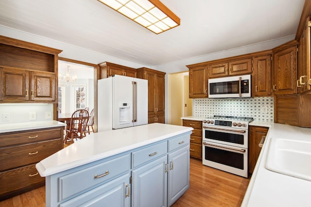 kitchen with white appliances, light countertops, and a kitchen island