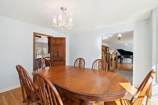 dining room with an inviting chandelier, wood finished floors, and baseboards