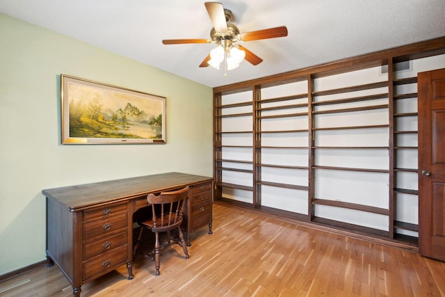 office space with light wood-style floors and a ceiling fan