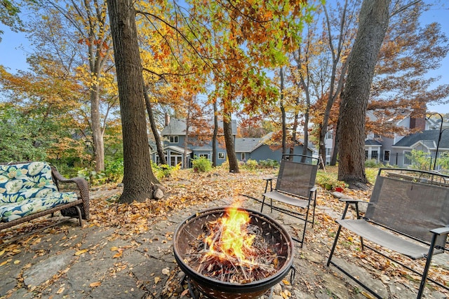 view of yard featuring a residential view and a fire pit