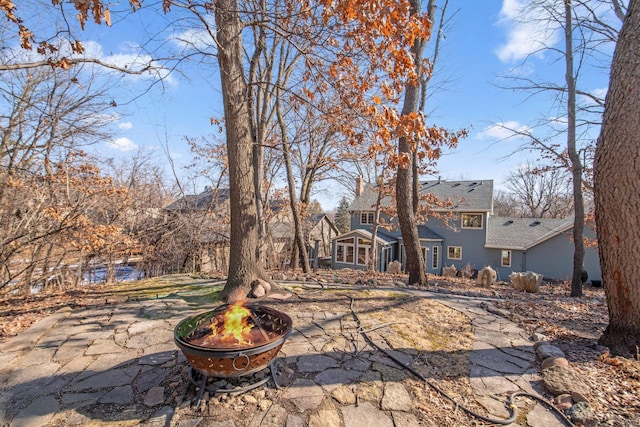 view of yard with a fire pit