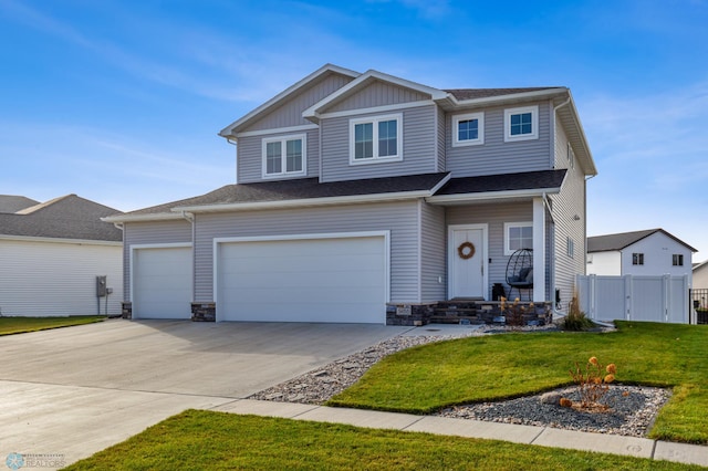 view of front of house with an attached garage, a front lawn, fence, stone siding, and driveway