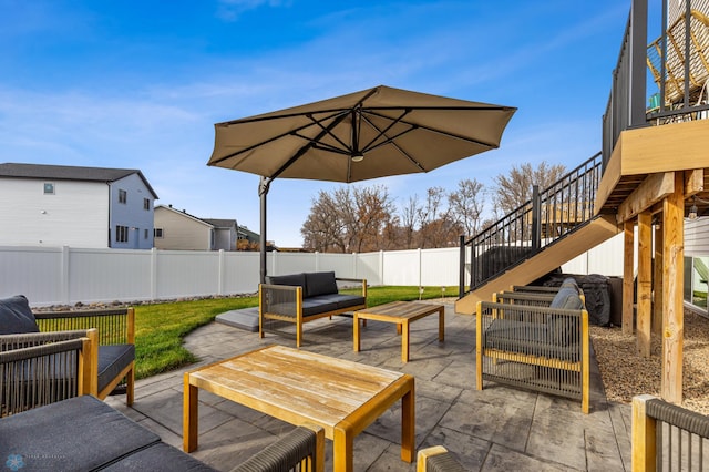 view of patio / terrace with an outdoor hangout area, stairs, and a fenced backyard