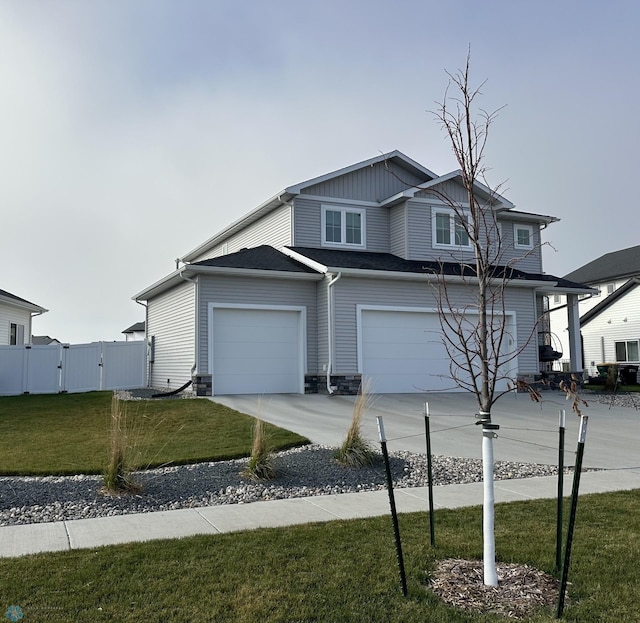 view of front of house with a front yard, a gate, fence, driveway, and stone siding