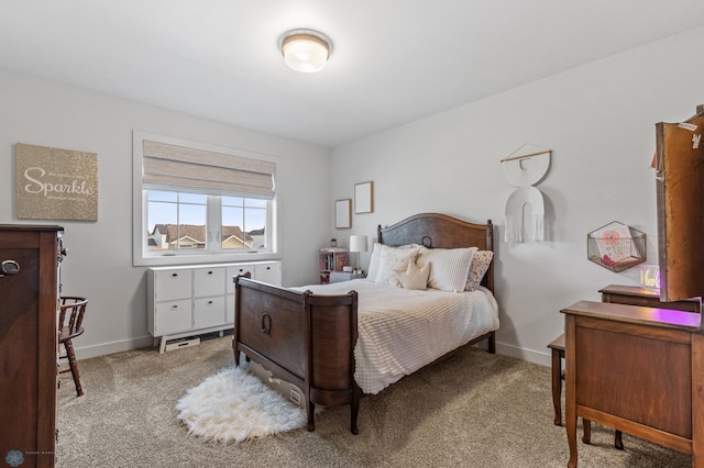 bedroom with light colored carpet and baseboards