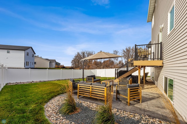 view of yard featuring a patio area, outdoor lounge area, stairs, and a fenced backyard