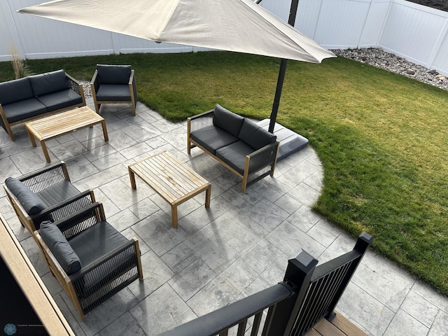 view of patio featuring an outdoor living space and fence