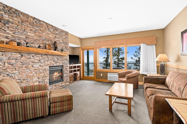 living area featuring a fireplace, a wall unit AC, and carpet floors