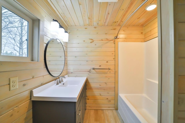 full bathroom with vanity, wood walls, a bathtub, wood finished floors, and wood ceiling
