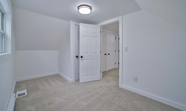 bonus room featuring carpet floors, a baseboard heating unit, baseboards, and visible vents