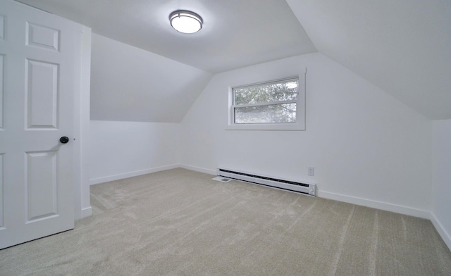 bonus room featuring vaulted ceiling, carpet floors, baseboards, and a baseboard heating unit