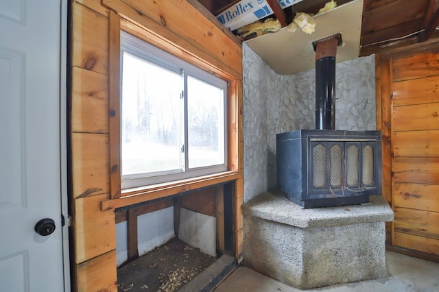 living area with a wood stove and concrete floors