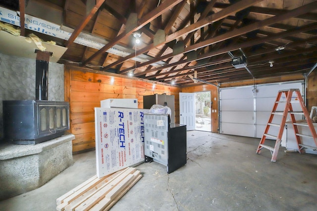 garage featuring a garage door opener and a wood stove