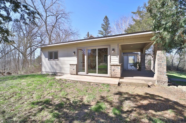 rear view of house with a yard