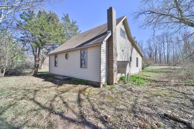 view of home's exterior featuring a chimney