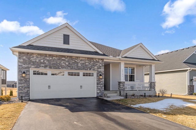 craftsman inspired home with aphalt driveway, roof with shingles, a porch, and an attached garage