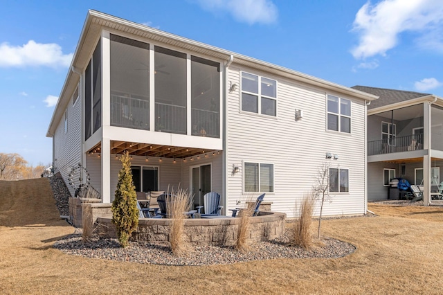 back of property featuring a patio area and a sunroom