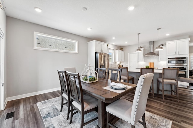 dining room featuring dark wood finished floors, visible vents, recessed lighting, and baseboards