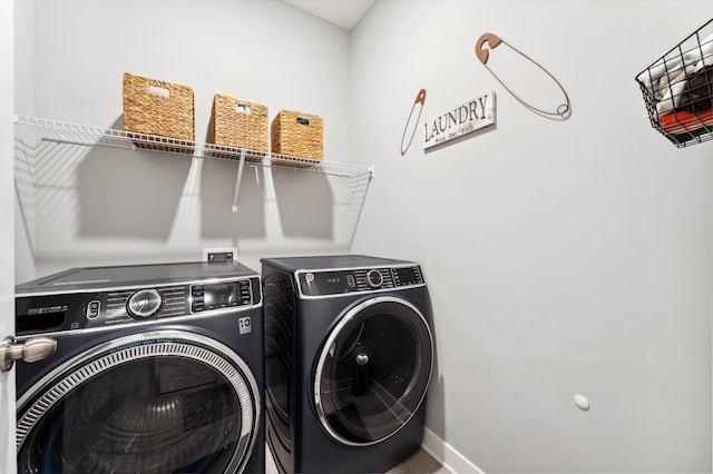 laundry room featuring baseboards, independent washer and dryer, and laundry area