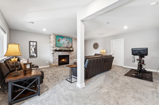 carpeted living area with recessed lighting, a large fireplace, and baseboards