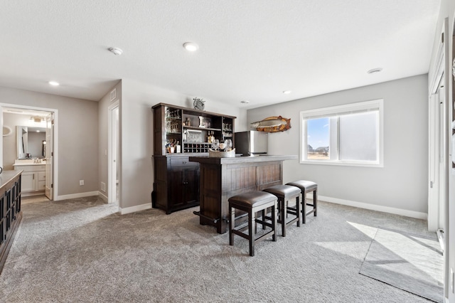 bar with fridge, recessed lighting, light colored carpet, and baseboards