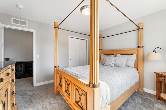 carpeted bedroom with visible vents, baseboards, a closet, and decorative columns