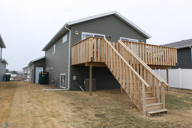 rear view of property with a wooden deck, stairs, central AC, and fence