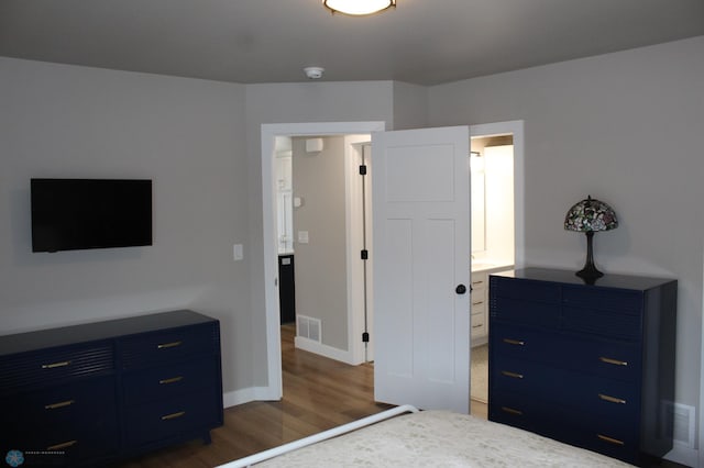 unfurnished bedroom with visible vents, baseboards, and wood finished floors