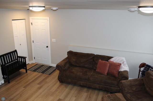 living room featuring light wood-style floors and baseboards