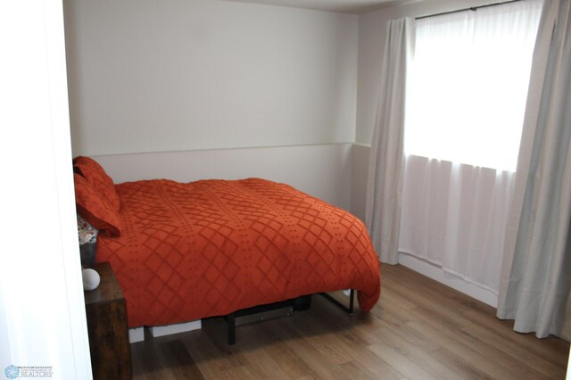 bedroom featuring wood finished floors