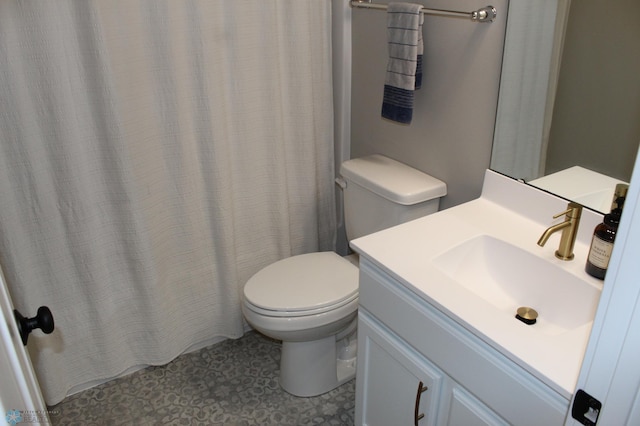 bathroom featuring toilet and vanity