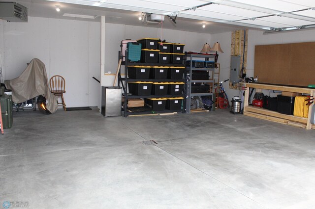 garage with electric panel and a garage door opener