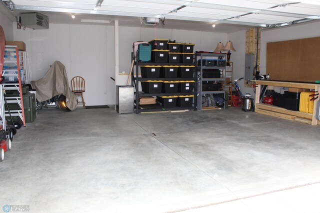 garage featuring electric panel and a garage door opener