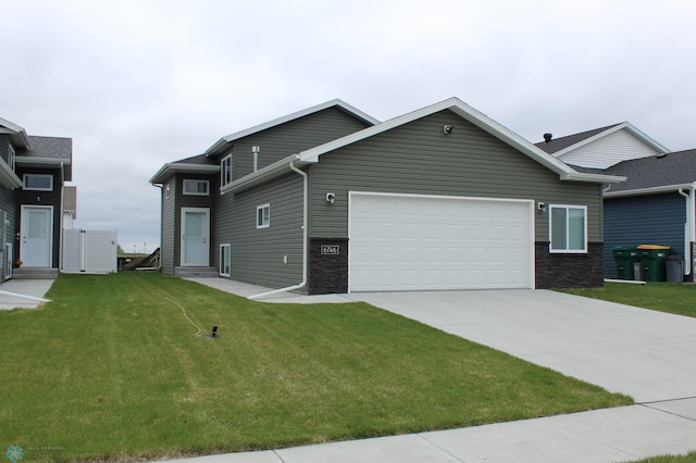 6746 Joseph St, Horace, ND 58047 - view of front of house featuring a garage, concrete driveway, a front lawn, and entry steps