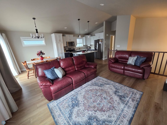 6746 Joseph St, Horace, ND 58047 - living area with lofted ceiling, light wood finished floors, a chandelier, baseboards, and recessed lighting
