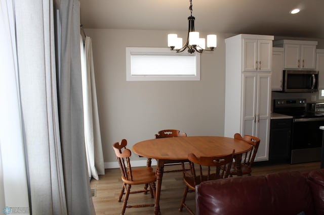 6746 Joseph St, Horace, ND 58047 - dining area featuring recessed lighting, a chandelier, light wood-style flooring, and baseboards