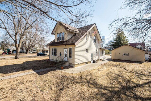 view of side of home featuring a shingled roof