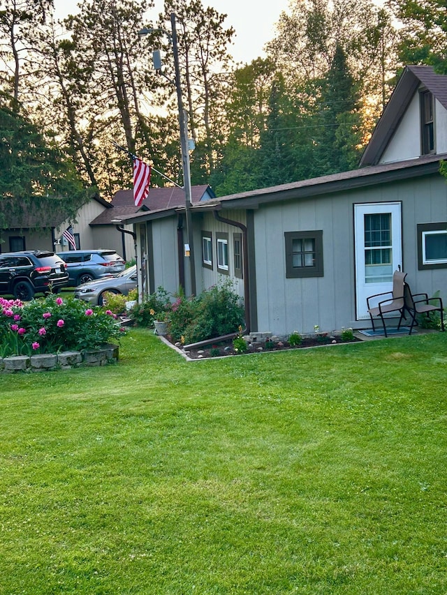 exterior space with a lawn and board and batten siding