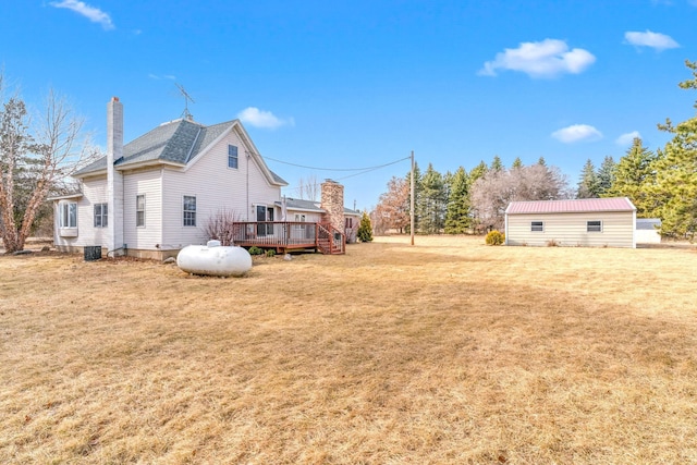 view of yard featuring central AC unit and a wooden deck