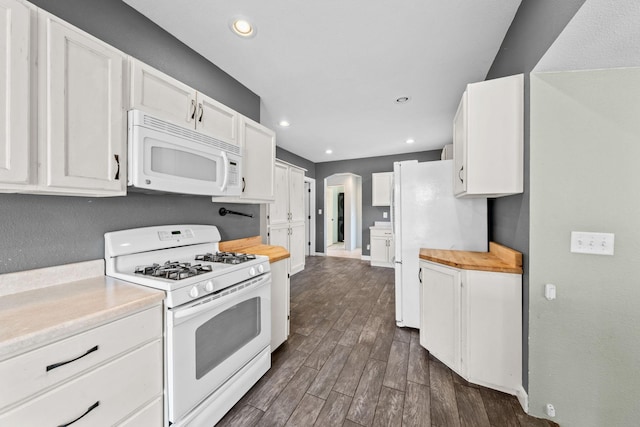 kitchen featuring white appliances, white cabinets, dark wood-style flooring, and wooden counters