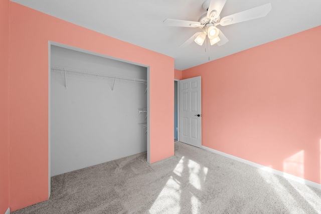 unfurnished bedroom featuring a closet, a ceiling fan, and carpet