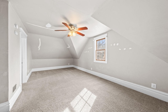 bonus room featuring vaulted ceiling, carpet flooring, a ceiling fan, and baseboards