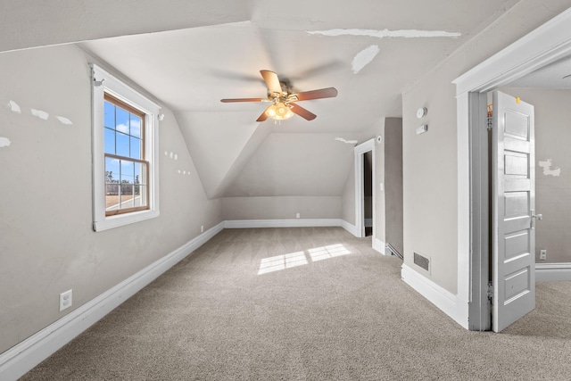 bonus room with vaulted ceiling, baseboards, a ceiling fan, and carpet floors