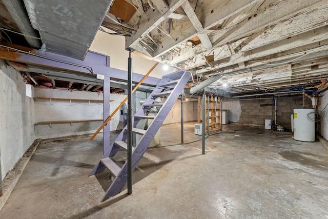 unfinished basement featuring stairway and water heater