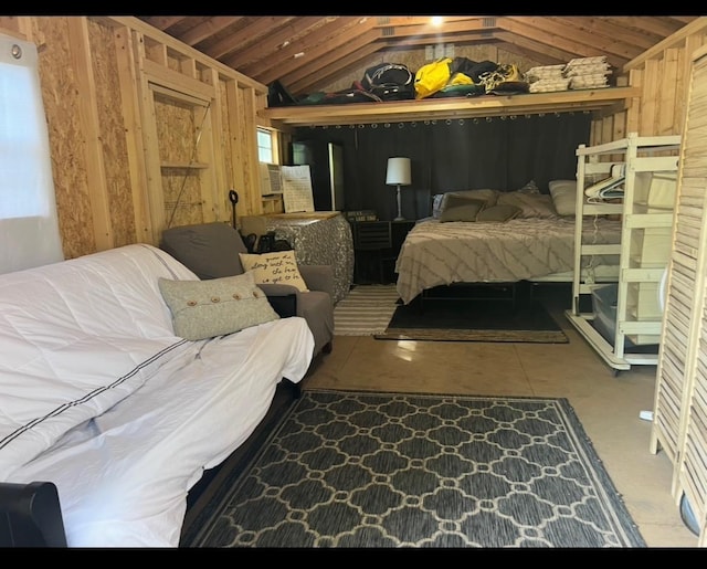 bedroom featuring wooden walls and vaulted ceiling