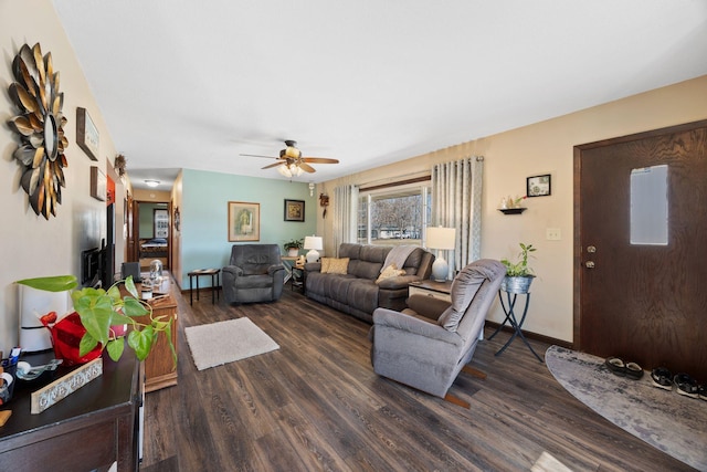 living area with wood finished floors, baseboards, and ceiling fan